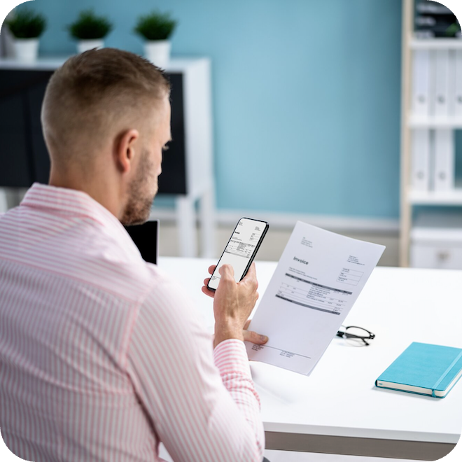 Man using his expense tracker on his phone to capture an invoice.